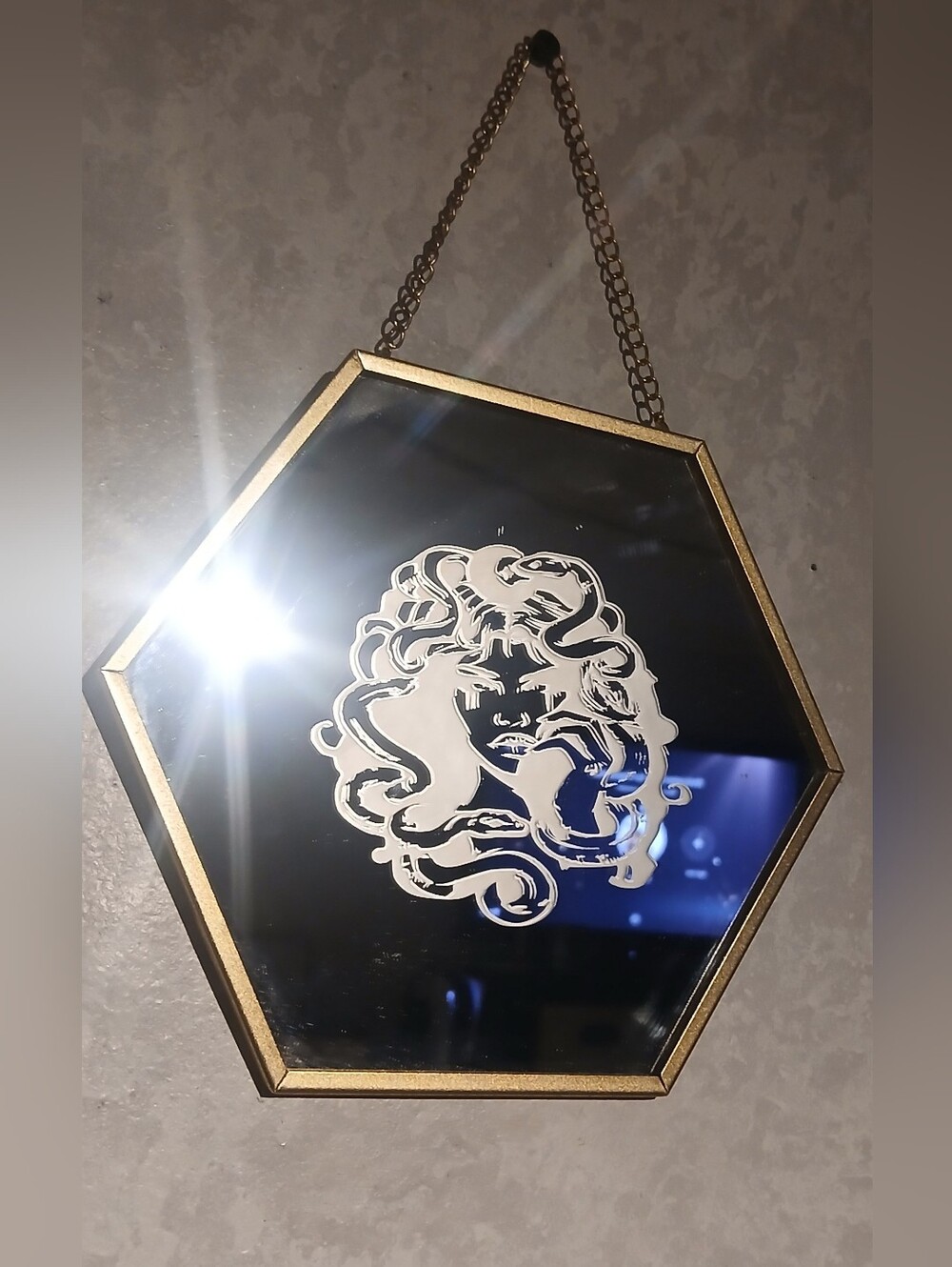 Gold Hexagonal Wall Mirror with White Medusa Design